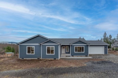 Completed single-storey home on a cleared lot under open sky