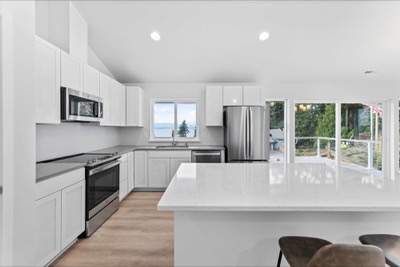 Kitchen of a completed home looking out over the water