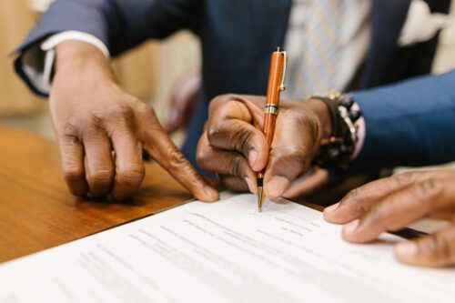 people reviewing and signing a construction loan agreement