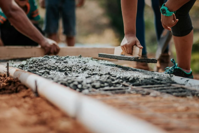 workers laying the foundation to a new building